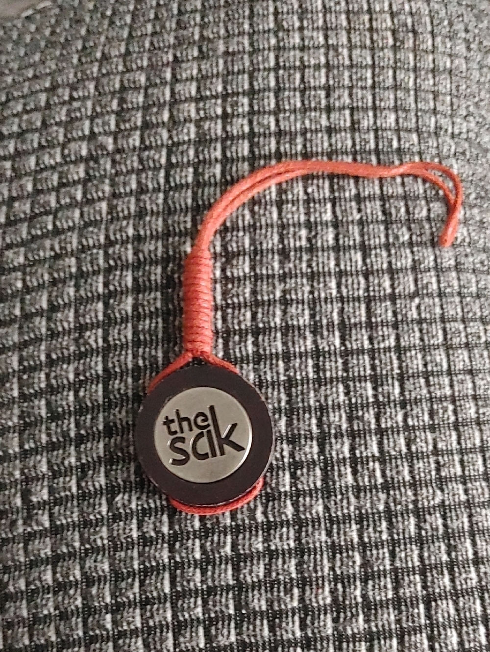 The Sak Rust Red Leather Logo Charm with Woven Loop-Replacement Tag